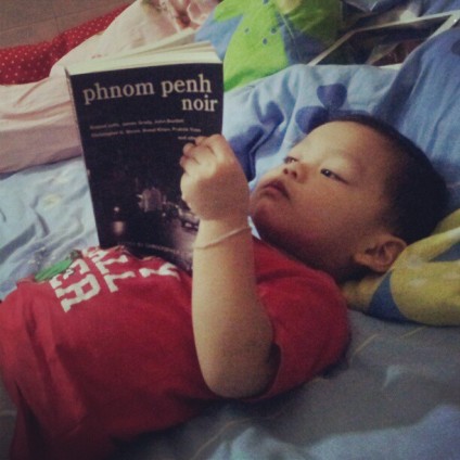 Vitou, my son, pretends to read Phnom Penh Noir